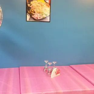 a pink tablecloth with a cake on it