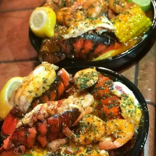 two plates of lobster and corn