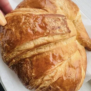 a person holding a croissant