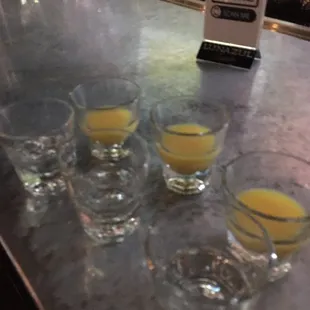 four glasses of orange juice