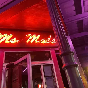 a neon sign on the outside of a restaurant
