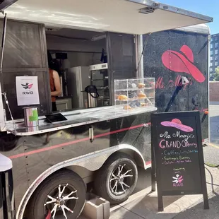 Coffee truck is on the right side of the bldg