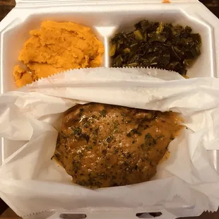 Smothered pork chops, greens and sweet potato soufflé
