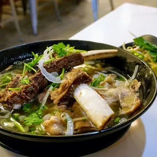 P7. Pho Beef Ribs: fresh rice noodles served with bean sprouts, basil, jalapeno slices and lime. Soup served in an oversized bowl ($20).