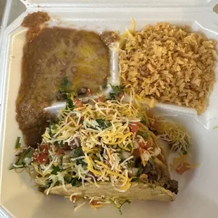 Two tacos hard shell plate with asada - rice and beans