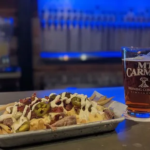 Loaded fries and Amber Ale, at the bar.