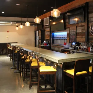 a bar with yellow chairs