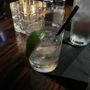 a glass of water and a lime slice