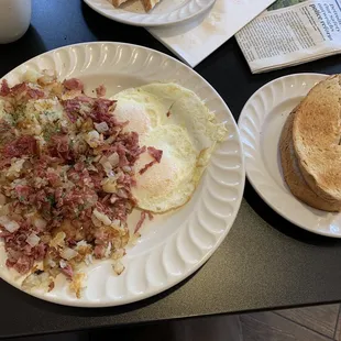 Nicely seasoned corn Corned Beef Hash &amp; Eggs over easy, with thick rye toast.