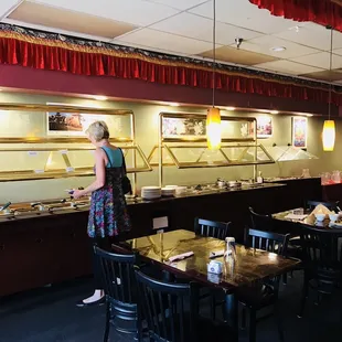 a woman standing in front of a buffet