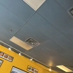 a yellow wall with pictures on it