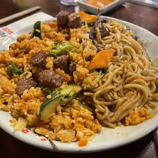 a plate of noodles with meat and vegetables