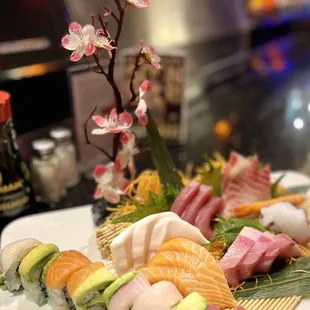 a plate of sushi with a cherry blossom in the background