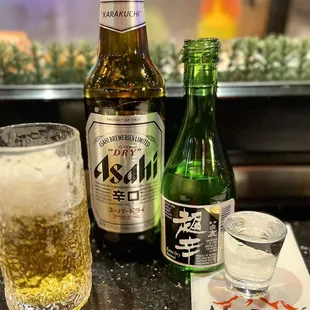 a glass of beer and a bottle of beer