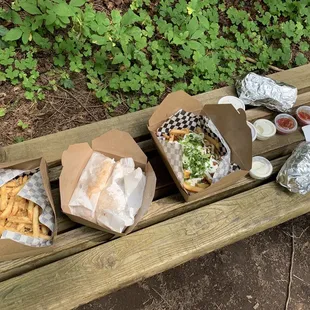 a picnic table with a variety of food items