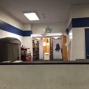 Ice skate renting area. Sign reads "Skate Sharpening 9am-9pm (Time Permitting During Peak Hours)