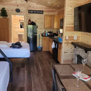 Full kitchen, queen bed, bunk bed (with larger bottom bunk) dining area and electric fireplace/heater.
