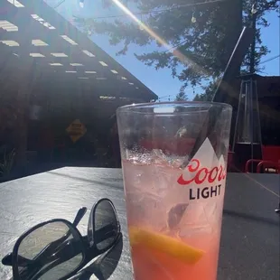 a drink and sunglasses on a table