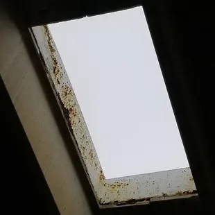 Skylights over the pool have rust and chipped paint