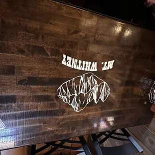 a wooden table with a menu on it