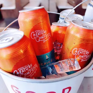 a bucket full of sodas