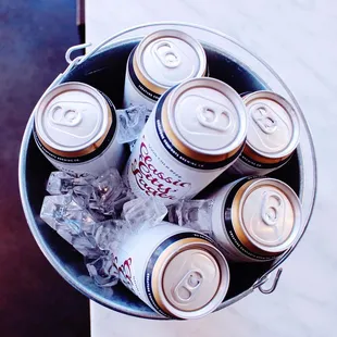 a bucket full of cans of beer