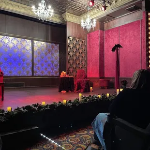 a stage with a red chair and a red chair