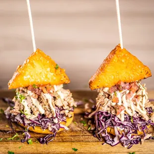 Arepita De Pernil:
Arepas (Corn meal), cabbage, slow roasted pork &quot;pibil&quot;, pico de gallo, housemade tartara, fried cheese.