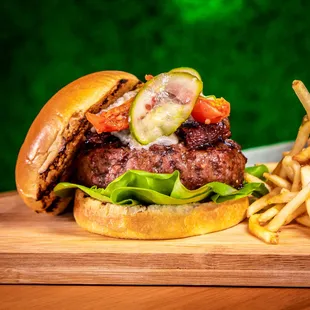 The best burger in town 2022-23&quot; 7.5oz certified angus beef, Bacon gastrique, blue cheese crumble, roasted tomatoes, pickle, brioche bun!