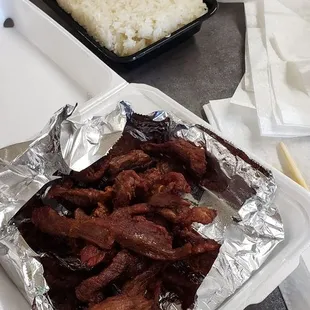  a tray of rice, meat, and vegetables