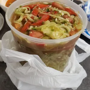  a woman sitting at a table with a bowl of soup