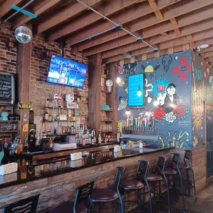 a bar with a chalkboard wall