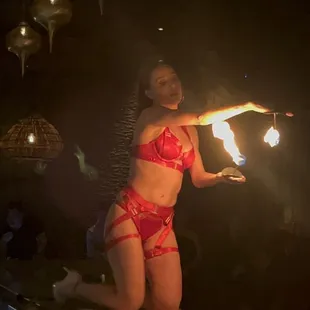 a woman in a red bikini with fire