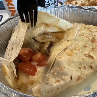 a burrito with a fork in it