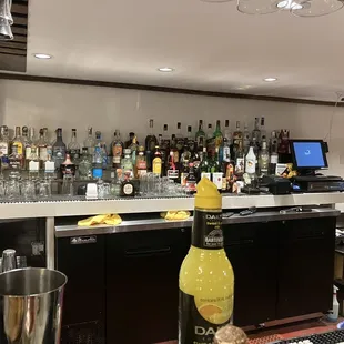 a bar with a lot of bottles of alcohol