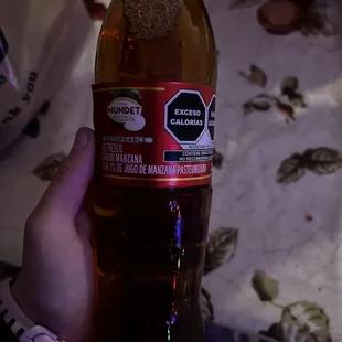 a person holding a bottle of beer