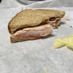 a half of a sandwich and chips