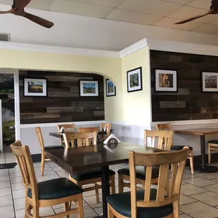 a dining area with tables and chairs