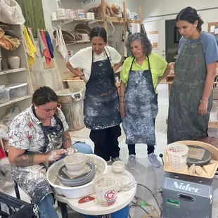 Family group learning to wheelthrow