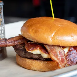 a bacon and cheese burger with fries