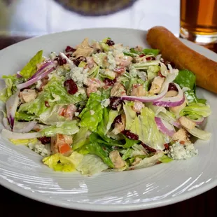 a plate of salad and a hot dog