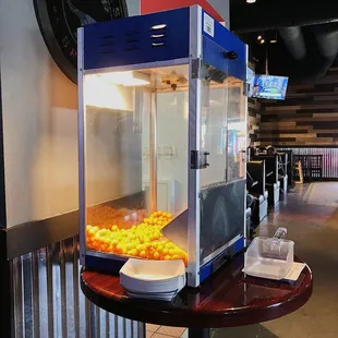 a popcorn machine filled with oranges