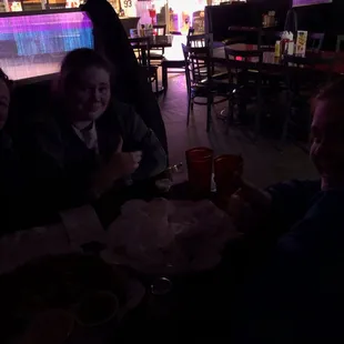 My friends and I sitting in the dark trying to eat our food. Horrible service, below average food, and terrible experience.