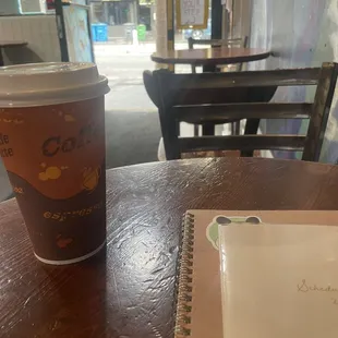 a cup of coffee and a notepad
