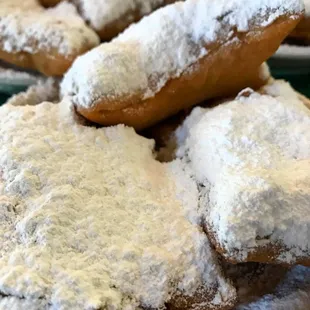 a pile of powdered doughnuts