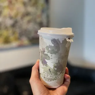 a hand holding a cup of coffee