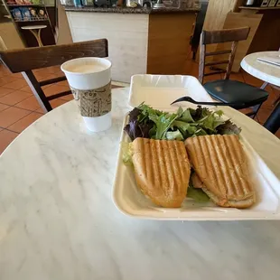 Smoked salmon sandwich with side salad, latte