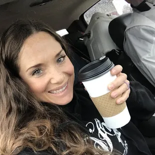 a woman holding a cup of coffee
