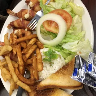 a plate of food with french fries and salad