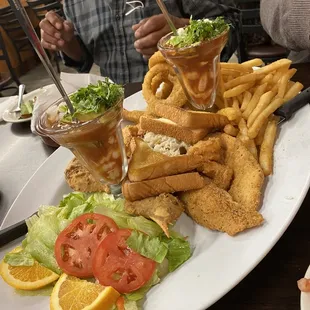 This plate can feed 2-3 people. Fried Crab, Fish, Shrimp, Rice with octopus, fries, onion rings, shrimp cocktail, and a fresh salad.